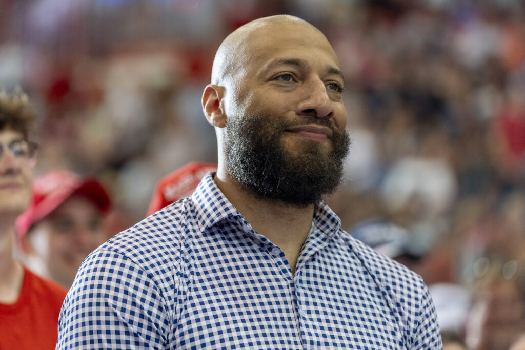 Royce White, candidate for U.S. Senate, listens as Republican presidential candidate former President Donald Trump speaks at a campaign rally, Saturday, July 27, 2024, in St. Cloud, Minn.