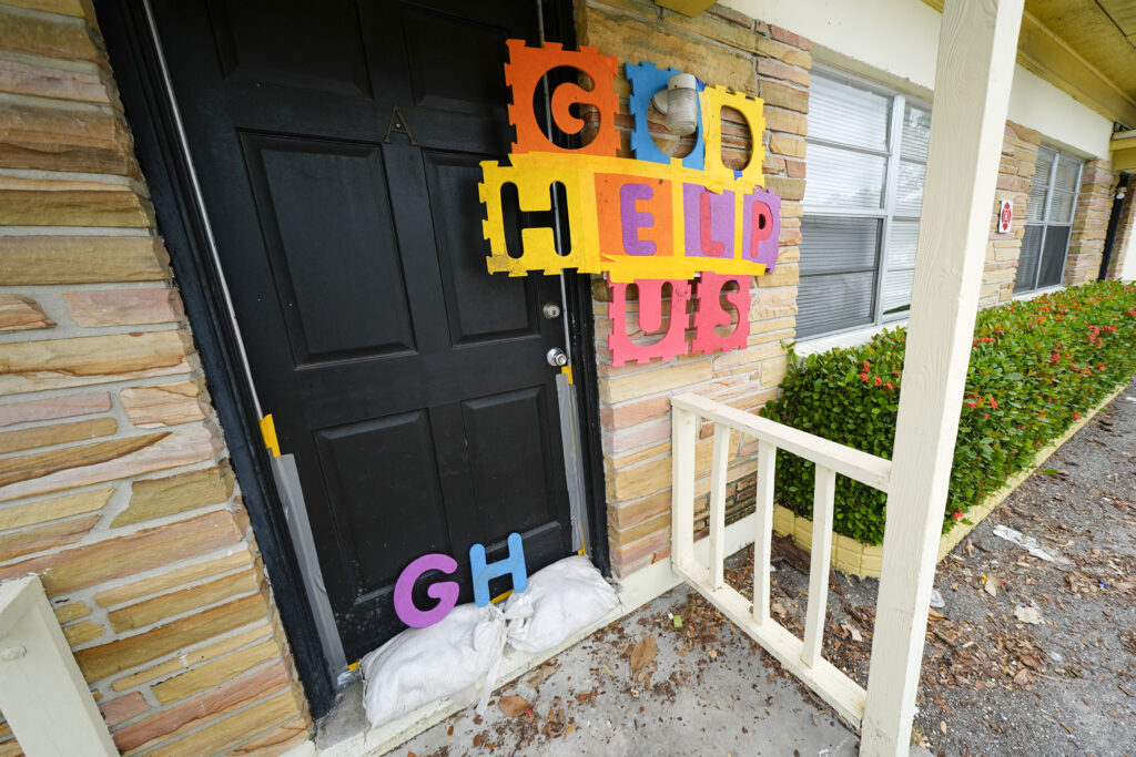 A message is seen outside of an apartment in the Davis Islands community of Tampa, Fla., as residents prepare for the arrival of Hurricane Milton, Tuesday, Oct. 8, 2024.