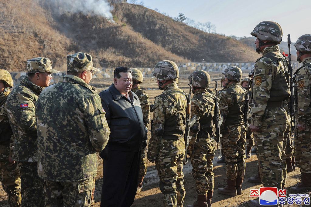 The North Korean leader, Kim Jong-un, meets soldiers during a visit to a western operational training base in North Korea, March 6, 2024.