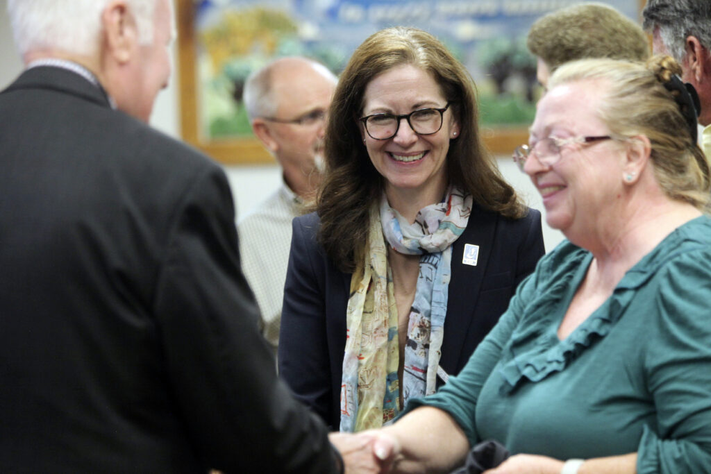 Kansas State Board of Education member Melanie Haas, center, D-Overland Park, watches as the winner of a national competition for school bus drivers is congratulated during a break in the board's regular monthly meeting, Wednesday, Oct. 9, 2024, in Topeka, Kan.