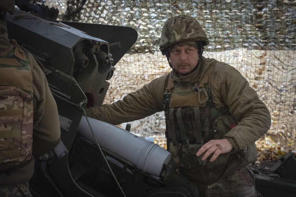 A serviceman of the 13th Brigade of the National Guard of Ukraine prepares to fire a Giatsint-B gun towards Russian positions near Kharkiv, Ukraine, Wednesday, Nov. 6, 2024.