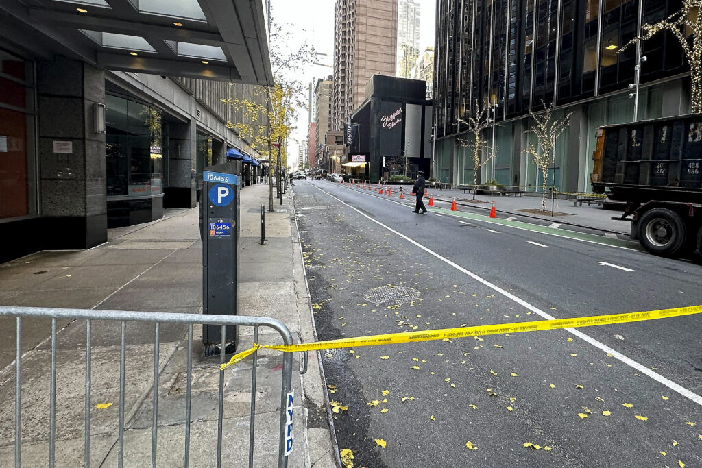 A New York police officer walks outside a hotel in midtown Manhattan where Brian Thompson, the CEO of UnitedHealthcare, was fatally shot Wednesday, Wednesday, Dec. 4, 2024, in New York. (AP Photo/Joe Frederick)