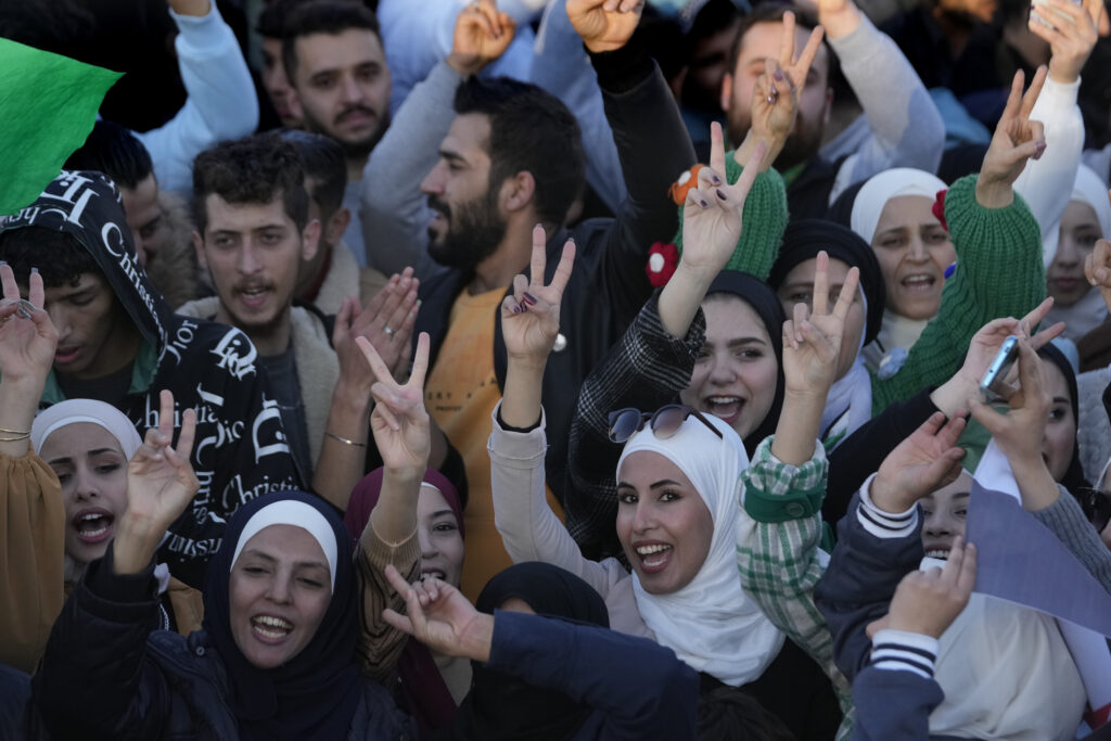 Syrians celebrate during a demonstration following the first Friday prayers since Bashar Assad's ouster, in Damascus' central square, Syria, on Friday, Dec. 13, 2024.