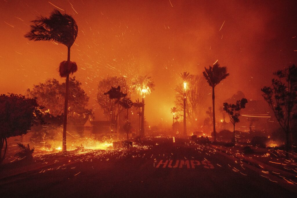 The Palisades Fire ravages a neighborhood amid high winds in the Pacific Palisades neighborhood of Los Angeles.