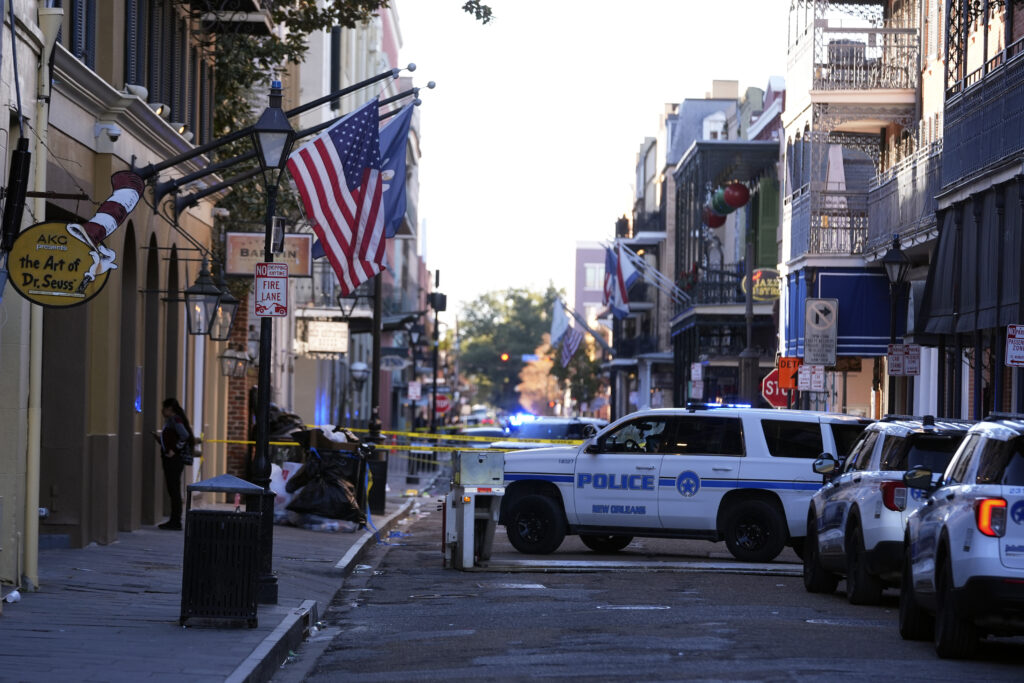 Emergency service vehicles form a security barrier to keep other vehicles out of the French Quarter after a vehicle drove into a crowd on New Orleans' Canal and Bourbon Street, Wednesday Jan. 1, 2025.