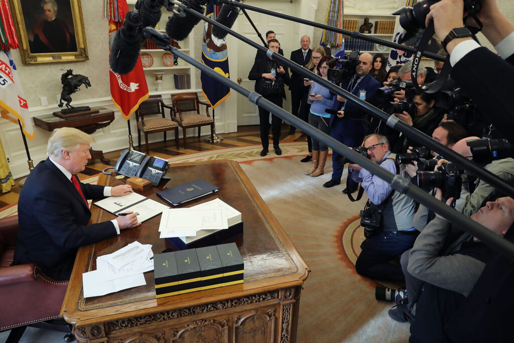 WASHINGTON, DC - DECEMBER 22: U.S. President Donald Trump signs sweeping tax reform legislation into law in the Oval Office December 22, 2017 in Washington, DC. Trump praised Republican leaders in Congress for all their work on the biggest tax overhaul in decades. (Photo by