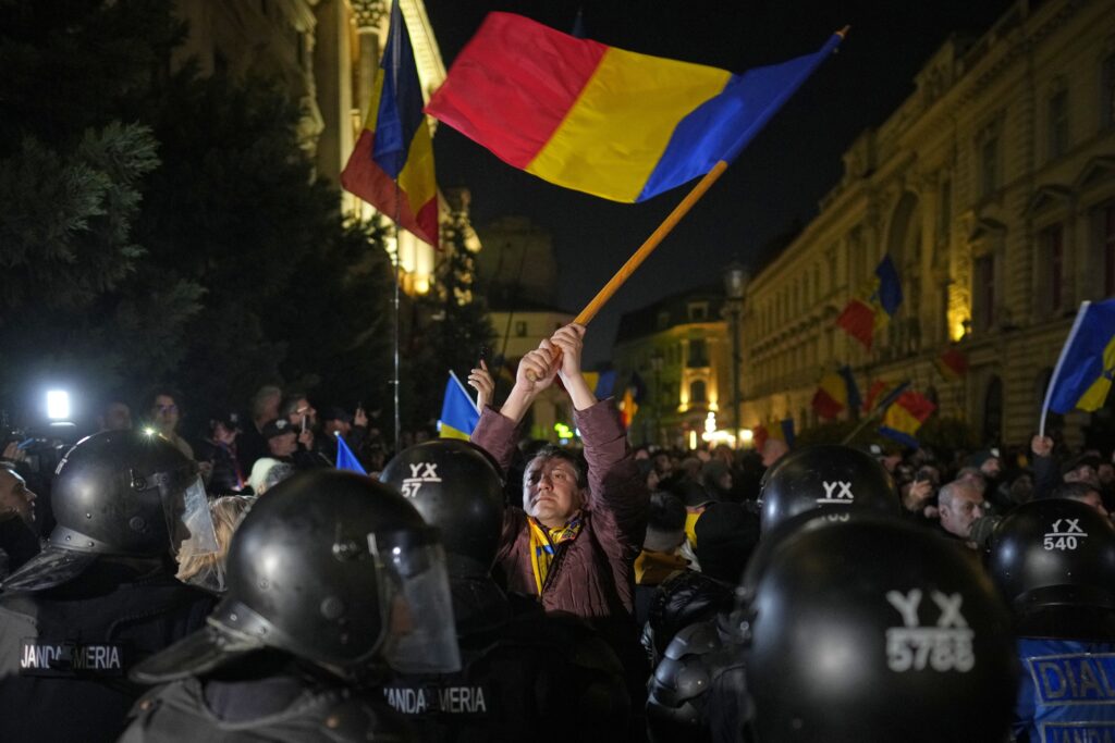 A supporter of Calin Georgescu reacts during a protest after Romania's electoral body rejected his candidacy in the presidential election rerun in Bucharest, Romania, Sunday, March 9, 2025. (