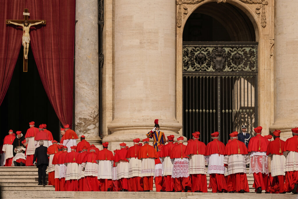 Cardinals walk through St. Peter's Square ahead of Pope Francis' coffin at the Vatican, Wednesday, April 23, 2025.