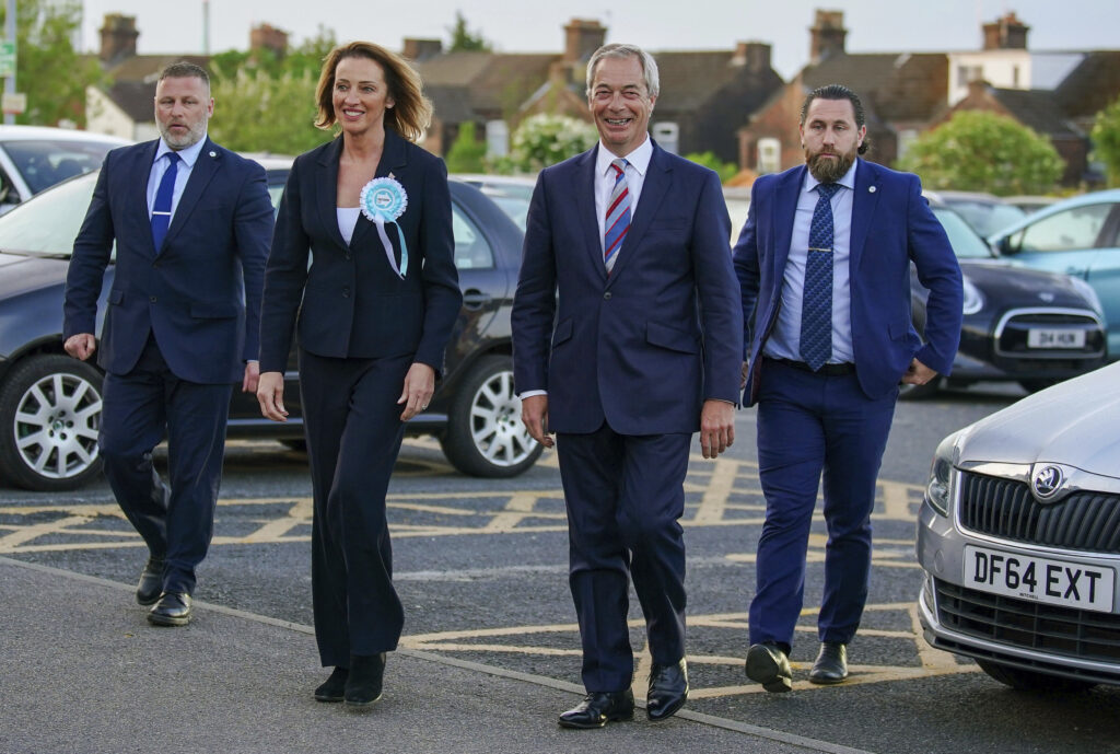 Reform UK candidate Sarah Pochin, second left and party leader Nigel Farage, second right, arrive at the DCBL Halton Stadium ahead of the result of the Runcorn and Helsby by-election at DCBL Halton Stadium, Widnes, Cheshire, Friday, May 2, 2025.