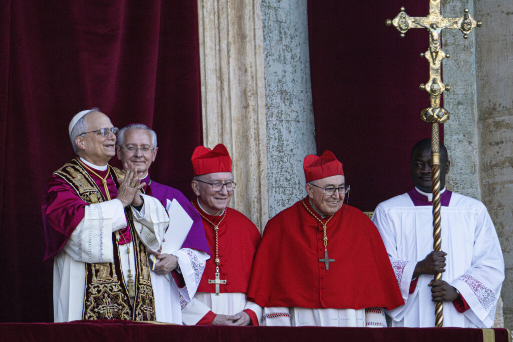 Newly elected Pope Leo XIV, left, formerly Cardinal Robert Francis Prevost, appears on the central loggia of St. Peter's Basilica at the Vatican shortly after his election as the 267th pontiff of the Roman Catholic Church, Thursday, May 8, 2025.