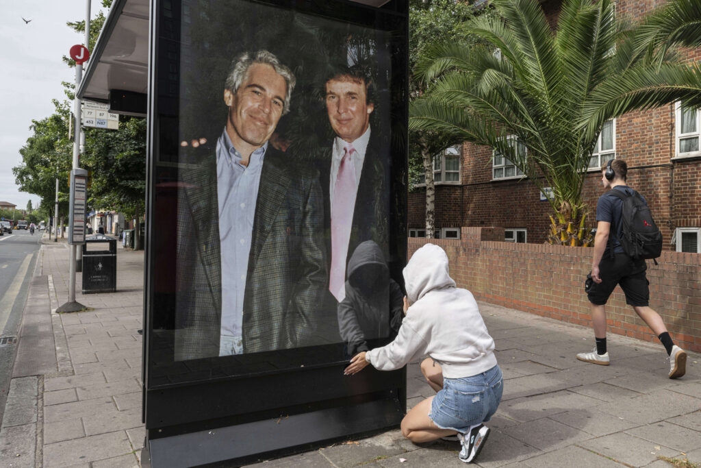 A poster showing President Trump and Jeffrey Epstein near the U.S. Embassy at London.