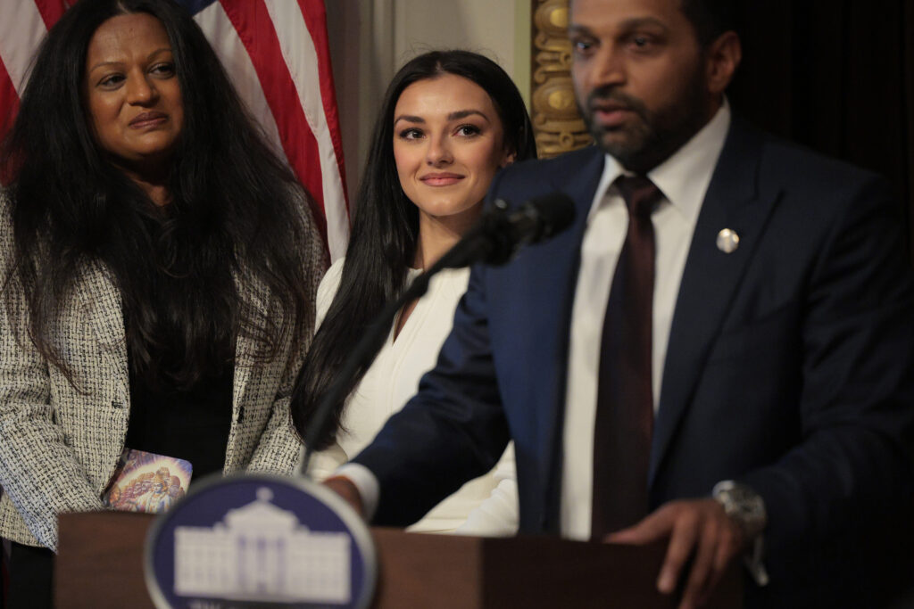 Kash Patel speaks as his girlfriend Alexis Wilkins looks on during his swearing in ceremony on February 21, 2025. in Washington, D.C.