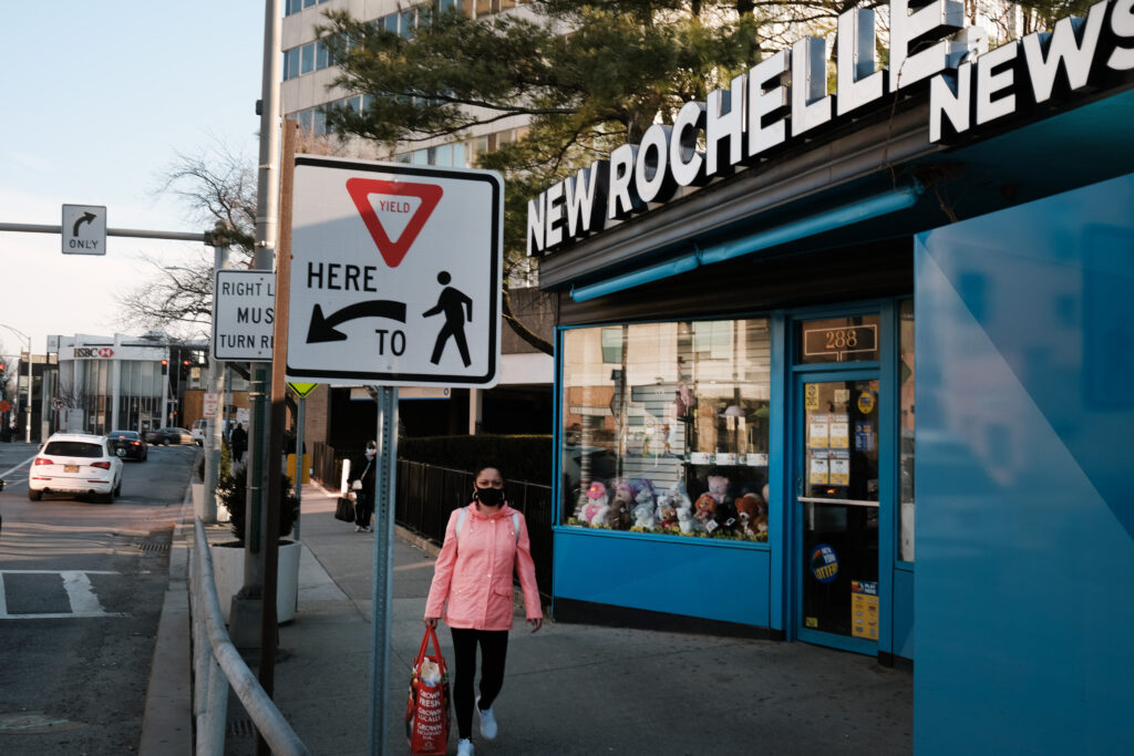 NEW ROCHELLE, NEW YORK - MARCH 11: People walk through the the city of New Rochelle on March 11, 2021 in New Rochelle, New York. One year ago New Rochelle was one of the first communities in America to see an outbreak of COVID-19. In March last year, it was confirmed that a COVID-19 case in New York was contact traced back to a lawyer from New Rochelle who attended religious gatherings that became the first “super-spreader” event in the country. (Photo by