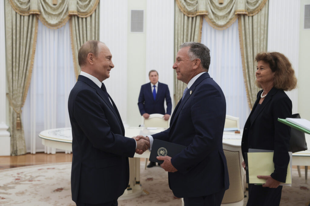 Russian President Vladimir Putin, left, and U.S. President Donald Trump's special envoy Steve Witkoff, right, shake hands during their meeting at the Kremlin in Moscow, Russia, Wednesday, Aug. 6, 2025. (Gavriil Grigorov, Sputnik, Kremlin Pool Photo via AP)