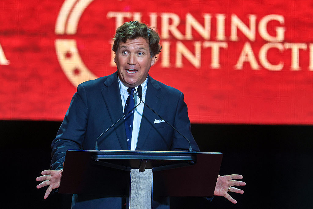 Political commentator Tucker Carlson speaks during the memorial service for political activist Charlie Kirk at State Farm Stadium on September 21, 2025 at Glendale.