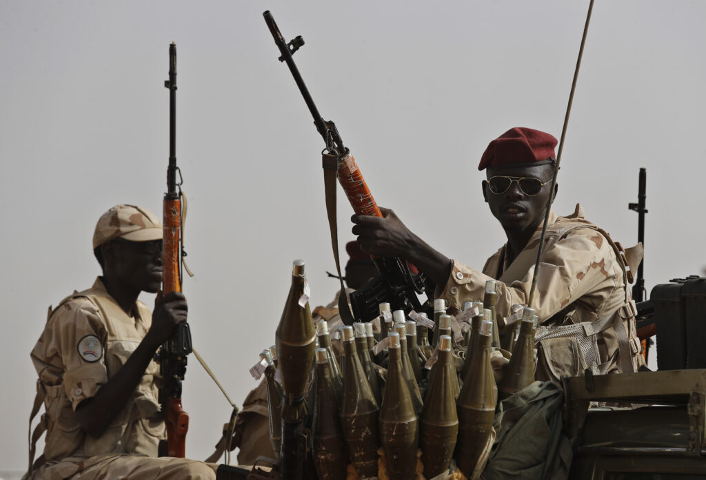 FILE - Sudanese soldiers from the Rapid Support Forces unit secure the area where Gen. Mohammed Hamdan Dagalo attends a military-backed tribe's rally, in the East Nile province, Sudan, June 22, 2019.