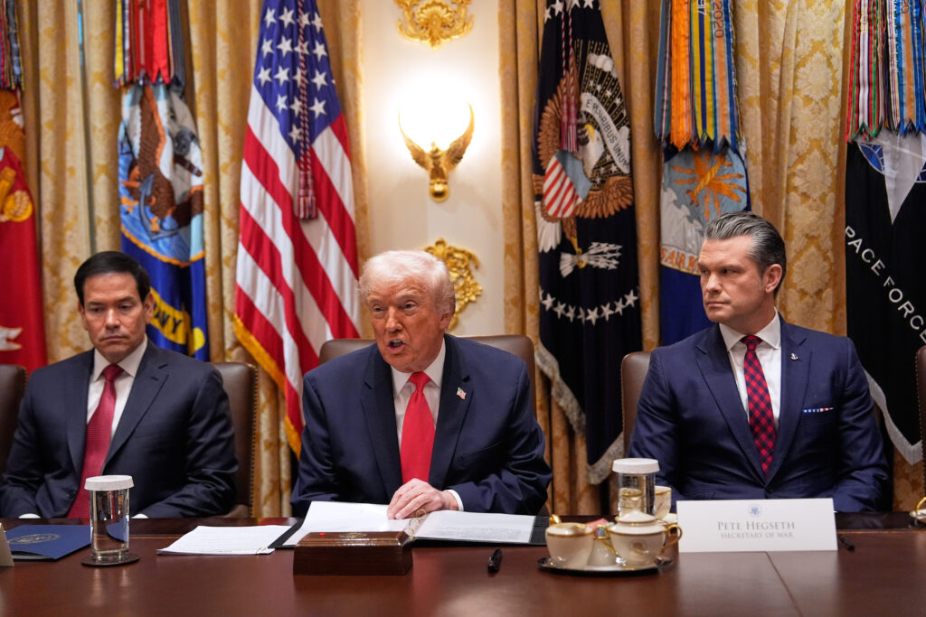 President Donald Trump speaks during a Cabinet meeting at the White House, Tuesday, Dec. 2, 2025, in Washington, as Secretary of State Marco Rubio, left, and Defense Secretary Pete Hegseth, right, look on.