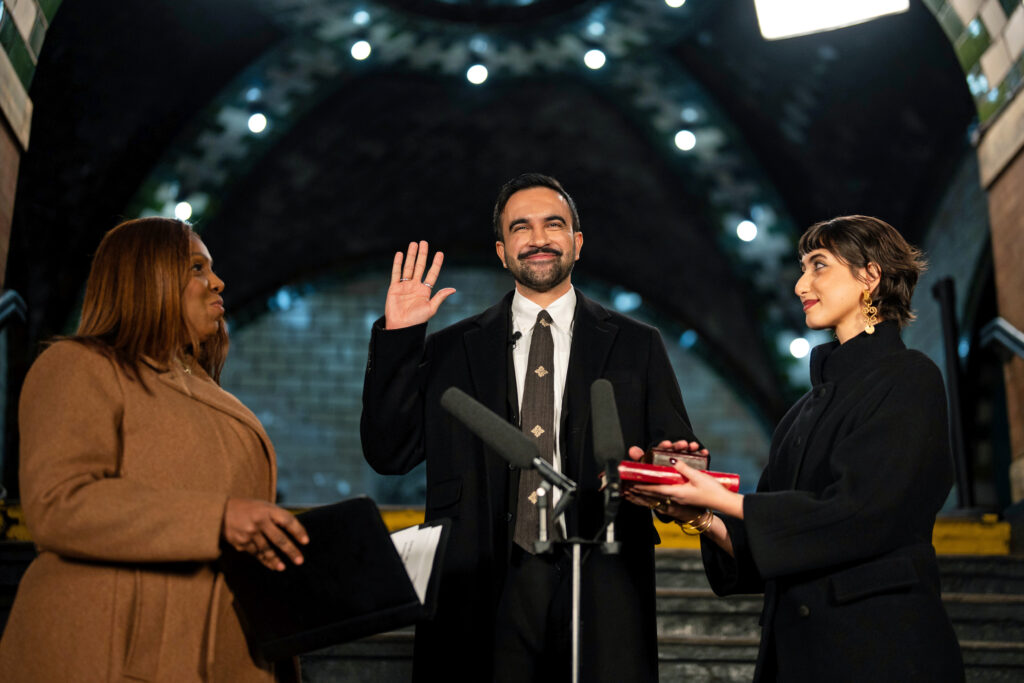 NEW YORK, NEW YORK - JANUARY 1: Zohran Mamdani is sworn in as New York City's 112th mayor by New York Attorney General Letitia James, left, alongside his wife Rama Duwaji, right, in the former City Hall subway station on January 1, 2026 in New York City. Mamdani’s term as mayor begins immediately in the new year, and a public inauguration will also take place in the afternoon at City Hall. (Photo by